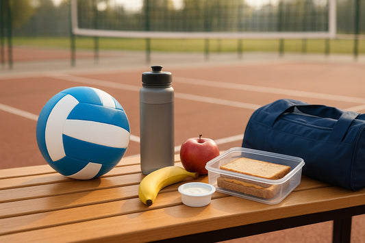 Courtside bench with a volleyball, water bottle, banana, apple and a packed lunch before practice